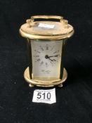 OVAL BRASS CARRIAGE CLOCK, MAKER WOODFORD EST 1860.