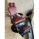 A VICTORIAN IRON AJUSTABLE DENTISTS CHAIR, WITH LEATHER UPHOLSTERED SEAT, ARMS, AND HEAD REST, AND