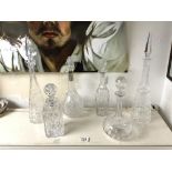 PAIR OF TALL ART DECO CUT GLASS CONICAL SHAPED DECANTERS; 45 CMS AND 4 OTHER CUT GLASS DECANTERS.