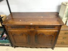 A 19TH-CENTURY FRENCH WALNUT BUFFET WITH TWO DOORS AND DRAWERS OVER AND CARVED FRIEZE DECORATION,