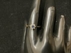 A 750 HALLMARKED GOLD DIAMOND AND SAPHIRE SET; 2.8 GMS; SIZE T.