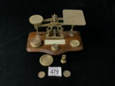 SET OF VICTORIAN BRASS POSTAL SCALES WITH 10 WEIGHTS; 20CM