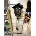 A CARVED BLACK FOREST CUCKOO CLOCK WITH A PRESENTATION PLAQUE FOR 1897.