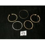 FOUR 375 HALLMARKED GOLD BANGLES, 19 GMS, AND A WHITE METAL BANGLE STAMPED 9 K, 4 GMS.