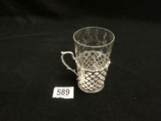 ENGRAVED GLASS BEAKER WITH HALLMARKED SILVER PIERCED HOLDER WITH RIBBED HANDLE. SHEFFIELD 1957,