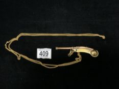 BRASS AND COPPER SS CANBERRA BOSANS WHISTLE; ON GOLD PLATED CHAIN.