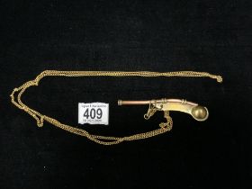 BRASS AND COPPER SS CANBERRA BOSANS WHISTLE; ON GOLD PLATED CHAIN.