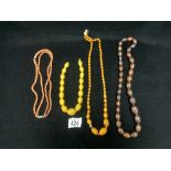 CORAL DOUBLE STRAND NECKLACE WITH SILVER CLASP AND THREE AMBER COLOUR NECKLACES.