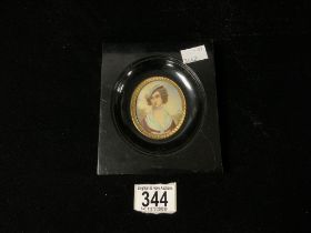 MINIATURE OF A LADY IN BLACK AND GILT FRAME.