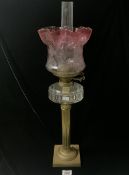 VICTORIAN BRASS CORINTHIAN COLUMN OIL LAMP WITH GLASS FONT AND ETCHED CRANBERRY GLASS SHADE; 62