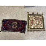 A MACHINE-MADE MEDIEVIL DESIGN WALL HANGING, 70X70 CMS, AND RED WOOLLEN PRAYER RUG.