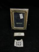 A 925 SILVER RECTANGULAR FRAME; APERTURE 9X6 CMS AND A 925 SIVER ENGINE TURNED MONEY CLIP.
