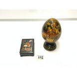 A RUSSIAN EGG-SHAPED BLACK AND GOLD LACQUER ORNAMENT, 18 CM, AND A TABLE SNUFF BOX.