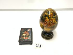 A RUSSIAN EGG-SHAPED BLACK AND GOLD LACQUER ORNAMENT, 18 CM, AND A TABLE SNUFF BOX.