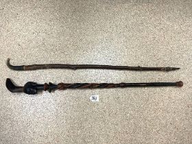 TWO AFRICAN WALKING STICKS, 1 WITH HORN END AND OTHER CARVED HEAD.