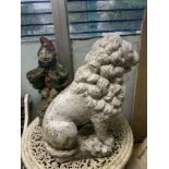 A STONE LION GARDEN FIGURE, 60 CMS HIGH, AND A STONE GARDEN GNOME.