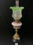 VICTORIAN BRASS OIL LAMP WITH FLORAL OPAQUE GLASS FONT, WITH ETCHED GREEN GLASS SHADE; 58CMS (