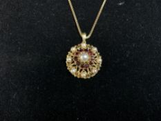 A 9CT GOLD GARNET AND CULTURED PEARL PENDANT ON CHAIN; 13 GRAMS.