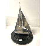 A 1950s CHROME SAILING BOAT MODEL ON CIRCULAR EBONISED BASE, 40 CMS.