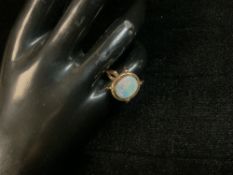 A YELLOW METAL DRESS RING SET WITH OVAL FIRE OPAL A/F, SIZE i HALF, 5.7 GRAMS.