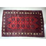 A RED GROUND WOOLEN BOKHARA PATTERN CARPET, 244X156 CMS.