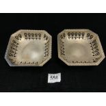 A PAIR OF HALLMARKED SILVER PIERCED CANTED CORNER SQUARE BON - BON DISHES ON SCROLL FEET,