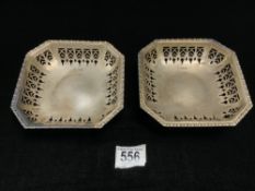 A PAIR OF HALLMARKED SILVER PIERCED CANTED CORNER SQUARE BON - BON DISHES ON SCROLL FEET,