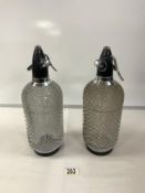 PAIR OF 1970'S GLASS AND METAL MESH SODA SYPHONS.
