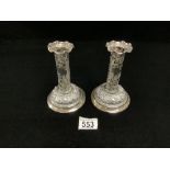 A PAIR OF VICTORIAN HALLMARKED SILVER PIERCED AND EMBOSSED CIRCULAR PILLAR CANDLESTICKS 15CMS,