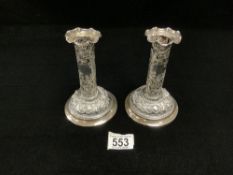 A PAIR OF VICTORIAN HALLMARKED SILVER PIERCED AND EMBOSSED CIRCULAR PILLAR CANDLESTICKS 15CMS,