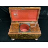 VICTORIAN FLAME MAHOGANY SARCHOPHAGUS SHAPED TEA CADDY ON BUN FEET WITH FITTINGS, 31X17 CMS.