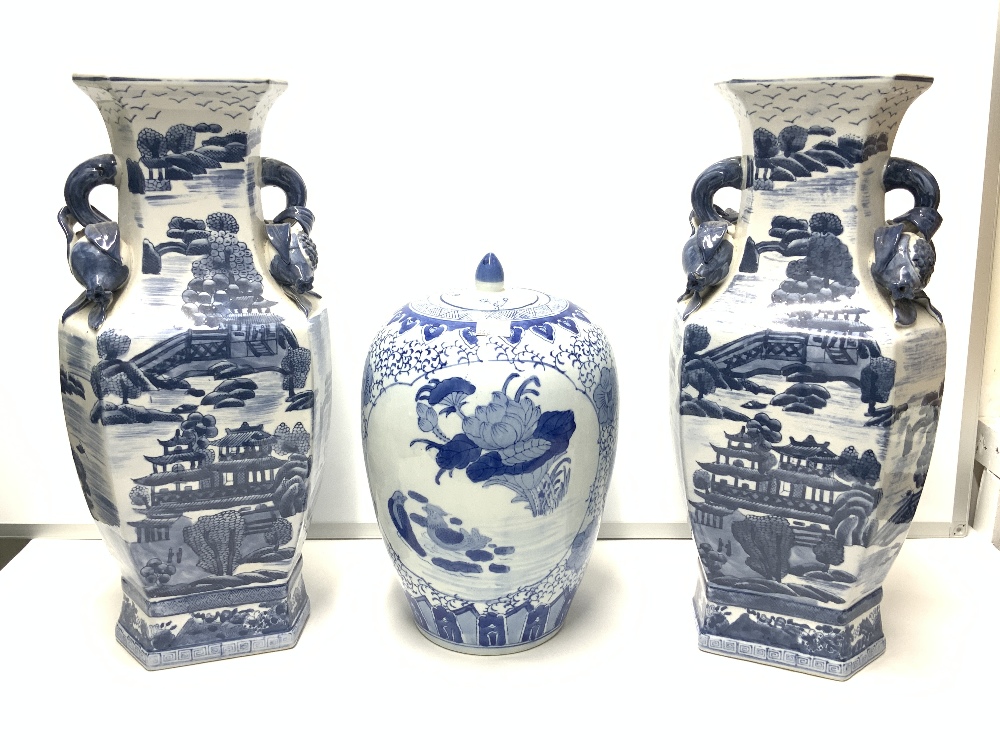 TWO BLUE AND WHITE IRONSTONE CHINESE STYLE VASES 48CM WITH A CHINESE BLUE AND WHITE GINGER JAR 32CM
