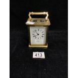 A BRASS CARRIAGE CLOCK WITH WHITE ENAMEL DIAL; THE MOVEMENT BY B & CO, PARIS; 11CMS