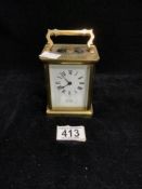 A BRASS CARRIAGE CLOCK WITH WHITE ENAMEL DIAL; THE MOVEMENT BY B & CO, PARIS; 11CMS