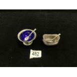 TWO HALLMARKED SILVER SALTS WITH SPOONS; 1 WITH BLUE GLASS LINER; 74 GMS.