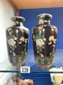 A PAIR OF ORIENTAL CLOISONNE VASES DECORATED WITH FLOWERS; 23 CMS.