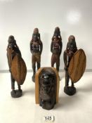 FOUR AFRICAN CARVED WOODEN FIGURES OF WARRIOR MEN AND WOMEN; 30 CMS AND CARVED BUST.