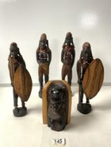 FOUR AFRICAN CARVED WOODEN FIGURES OF WARRIOR MEN AND WOMEN; 30 CMS AND CARVED BUST.