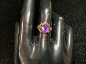 A 375 HALLMARKED GOLD RING SET WITH OVAL AMETHYST; SIZE N & HALF; 2.2 GRAMS.