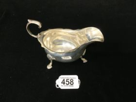 HEAVY HALLMARKED SILVER SAUCE BOAT WITH SCROLL HANDLE AND HOOF FEET; LONDON 1913; 178 GRAMS.