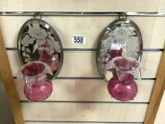 A PAIR OF OVAL MIRRORED AND CRANBERRY GLASS WALL SCONCES; 20 CMS.