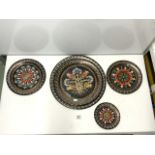 A SET OF FIVE CIRCULAR GRADUATING INDIAN PAINTED COPPER WALL PLATES; 38CMS LARGEST.