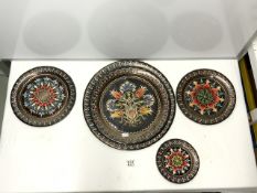 A SET OF FIVE CIRCULAR GRADUATING INDIAN PAINTED COPPER WALL PLATES; 38CMS LARGEST.