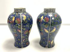 A PAIR OF ROYAL DOULTON BUDGIE DECORATED PORCELAIN VASES; 17 CMS.