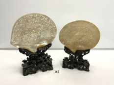 TWO NINETEENTH-CENTURY CHINESE CARVED MOTHER O PEARL SHELL PLAQUES ON CARVED HARDWOOD STANDS;