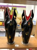 A PAIR OF BLACK ART GLASS SHAPED VASES; 43 CMS.