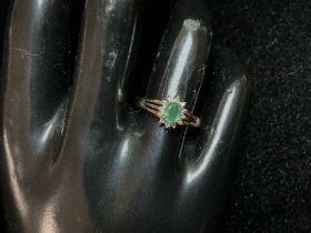 A 9CT HALLMARKED GOLD RING; SET WITH SMALL DIAMONDS AND EMERALD; SIZE O; 1.6 GMS.