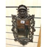 ORNATE BRASS WALL MIRROR WITH BACCUS HEAD DECORATION; 26X46 CMS.