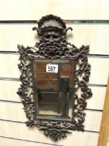 ORNATE BRASS WALL MIRROR WITH BACCUS HEAD DECORATION; 26X46 CMS.