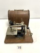 A SMALL VINTAGE HAND SEWING MACHINE ' FEDERATION ' IN OAK CASE.
